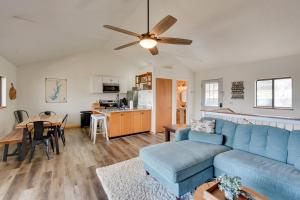 a living room with a blue couch and a kitchen at 3-Unit Combo w/ Dock on Lake Keowee - Hike & Fish! in Seneca