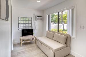 a living room with a couch and a tv at 4 Mi to Surfside Beach! North Miami Apt in North Miami