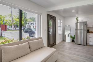a living room with a couch and a kitchen at 4 Mi to Surfside Beach! North Miami Apt in North Miami