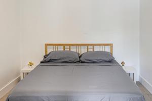a bed with two pillows on it in a room at 4 Mi to Surfside Beach! North Miami Apt in North Miami +15 photos