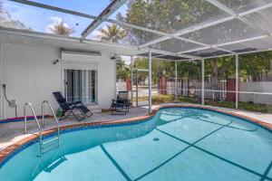 a swimming pool with a pergola and a patio at 4 Mi to Surfside Beach! North Miami Apt in North Miami