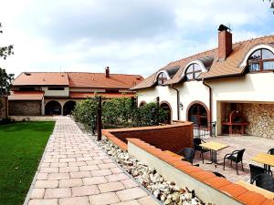 a house with a patio and a courtyard at Hotel Vinopa in Hustopeče