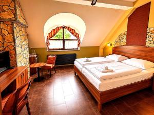 a bedroom with a large bed and a window at Hotel Vinopa in Hustopeče