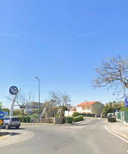 a street with a car driving down the road at Vivenda Santos in Albufeira +1 photo