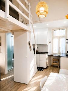 a room with a loft bed and a kitchen at Sanremo Apartments - Marilux in Sanremo