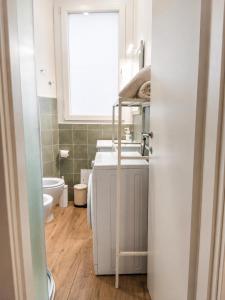 a bathroom with a sink and a toilet and a window at Sanremo Apartments - Marilux in Sanremo +7 photos