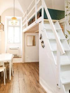 a room with a loft bed and a dining room with a table at Sanremo Apartments - Marilux in Sanremo