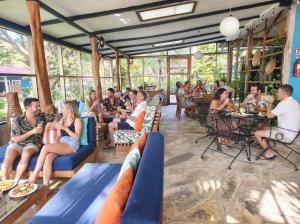 a group of people sitting in a restaurant at Xalli Beach Hotel in Altagracia