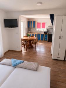 a living room with a table and a kitchen at Apartments Butkovic in Hvar