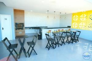 a dining room with a table and chairs at Praia Studios in Vila Velha