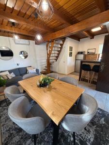 a dining room with a wooden table and chairs at Villa Verdea Lopatinec in Lopatinec