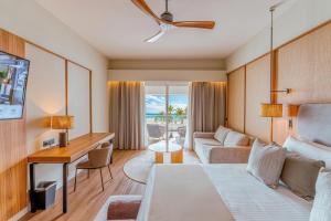 a bedroom with a bed and a desk and a couch at Santo Domingo Bay Convention Resort & Casino in Boca Chica