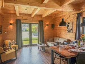 a living room with a table and a couch at Rattendorf 13B in Rattendorf