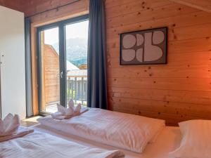 a bedroom with a bed with a large window at Rattendorf 13B in Rattendorf
