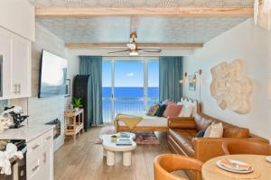 a living room with a couch and a bed at Penthouse Oceanfront Studio VR + Mural + Minibar in Myrtle Beach