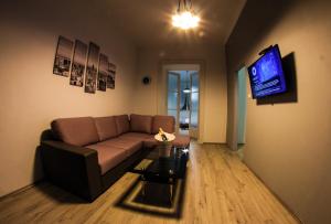 a living room with a couch and a tv at Apartment Jasmin in Rijeka