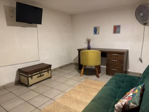 a living room with a green couch and a desk at Casa Matia in Guadalajara +61 photos