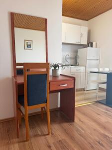 a desk with a chair and a table in a kitchen at Studio Mandre 3557a in Kolan