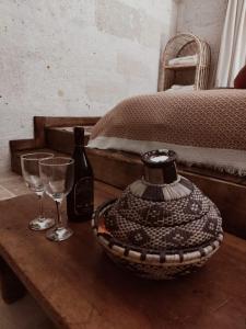 a table with a vase and two glasses on it at Route Cappadocia in Avanos +89 photos