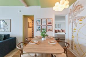 a living room with a wooden table and chairs at Penthouse 1BR + Bunk Room Boardwalk View Zone in Myrtle Beach