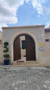 a building with a large wooden door with an arch at Route Cappadocia in Avanos