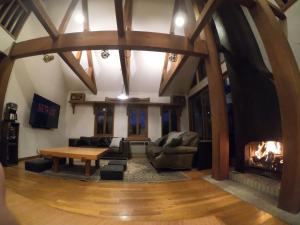 a living room with a table and a fireplace at The Joint in Hakuba