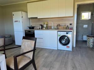 a kitchen with a washing machine and a refrigerator at Hamallaj Bliss in Draç