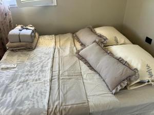 a bed with pillows on it in a room at Hamallaj Bliss in Draç