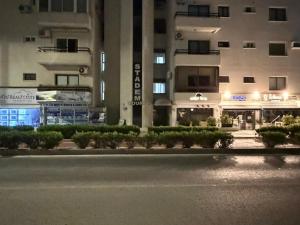 an empty street in front of a building at night at The Seafront Pearl in Larnaca +6 photos