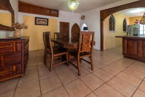 a dining room with a wooden table and chairs at Hotel Casa Grande in Taxco de Alarcón