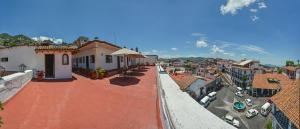 a view of a city with a mountain in the background at Hotel Casa Grande in Taxco de Alarcón