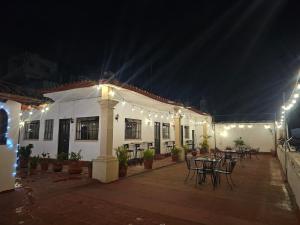 a patio with tables and chairs in a building at night at Hotel Casa Grande in Taxco de Alarcón +6 photos