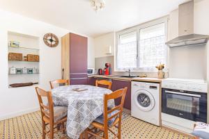 a kitchen with a table and chairs and a sink at Appartement À Saint-Pierre-d'Oléron in Saint-Pierre-dʼOléron