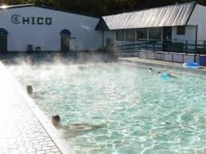 a pool of water with people swimming in it at Near Yellowstone Park and Chico Hot Springs in Emigrant