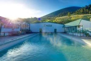 a large pool of blue water in front of a building at Near Yellowstone Park and Chico Hot Springs in Emigrant