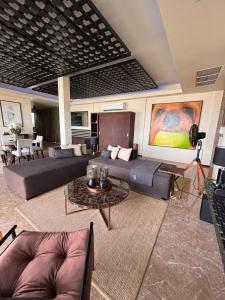 a large living room with couches and a table at Villa Manolo in Ban Bang Makham