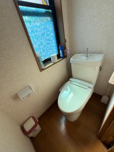 a small bathroom with a toilet and a window at Azumi Holiday House in Azumino +17 photos