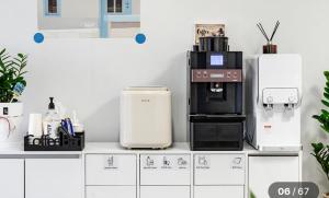 a counter with a coffee maker and a coffee machine at Hole in One Hotel in Chuncheon