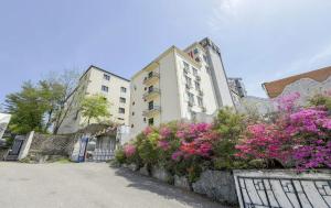 a street with flowers in front of a building at Hole in One Hotel in Chuncheon