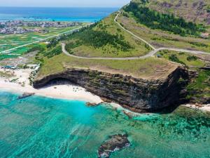 an aerial view of a beach with a large cliff at Homestay Đại Nghĩa in Quảng Ngãi