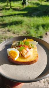 a piece of bread with eggs and broccoli on a plate at Nirvana bungalow's in Boras +18 photos