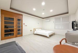 a bedroom with a bed and a flat screen tv at Hole in One Hotel in Chuncheon +87 photos