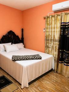 a bedroom with a bed with a leopard print blanket on it at Mammee Bay Hideaway in Ocho Rios