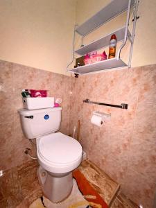 a bathroom with a white toilet in a room at Mammee Bay Hideaway in Ocho Rios +10 photos