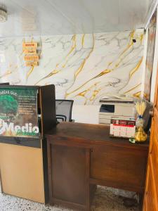 an office with a desk and a wall at Hotel Colonial El Gran Fénix in Tunja