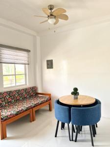 a living room with a couch and a table at Zand Pointe Suites in General Luna
