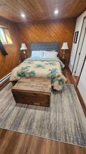 a bedroom with a bed and two lamps and a rug at Modern Two Bedroom Basement Apartment in Saint John