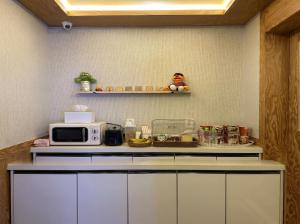 a kitchen with a microwave and a counter top at 대구 동천 스위트 호텔 in Daegu +8 photos
