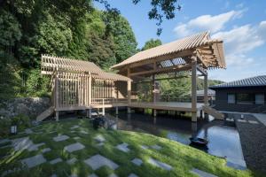a wooden gazebo in the middle of a garden at Banyan Tree Higashiyama Kyoto in Kyoto