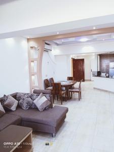 a living room with a couch and a table at Porto Sokhna Marina Towers sea view in Ain Sokhna